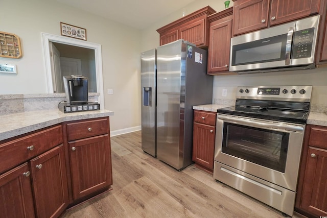 141 Baylee Cir, Galivants Ferry, SC 29544 - kitchen featuring appliances with stainless steel finishes, light wood-style flooring, light countertops, and baseboards