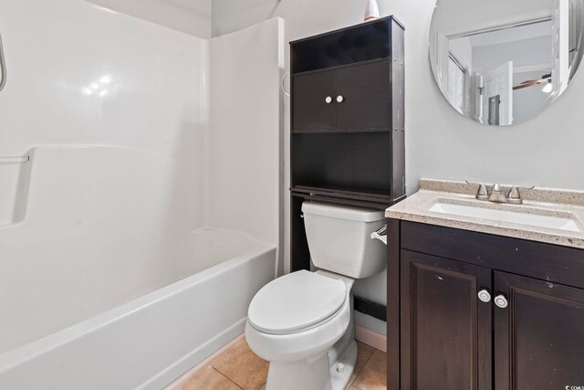 full bathroom with bathing tub / shower combination, toilet, vanity, and tile patterned flooring