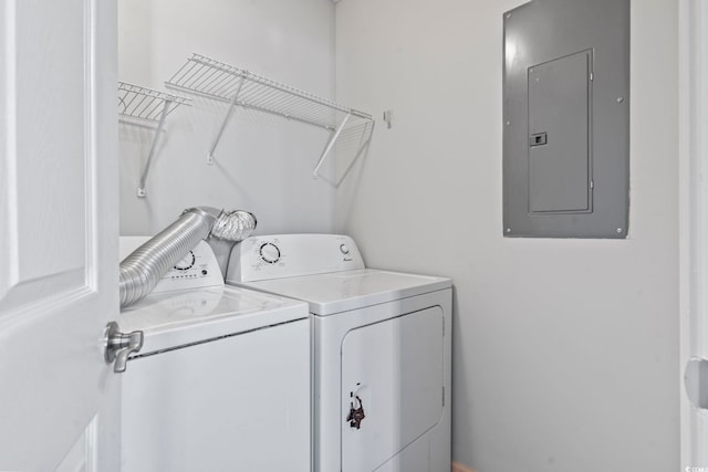 clothes washing area featuring electric panel and independent washer and dryer