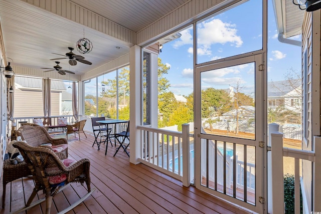 sunroom with a wealth of natural light and ceiling fan