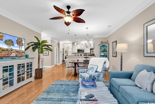 living room featuring crown molding, ceiling fan with notable chandelier, and light hardwood / wood-style flooring