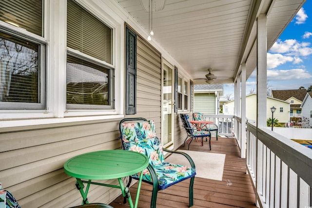 wooden terrace with ceiling fan and covered porch