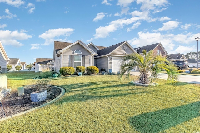 view of front of property featuring a garage and a front lawn