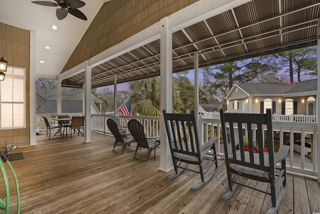 deck at dusk featuring ceiling fan