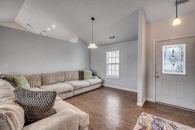 living room with dark hardwood / wood-style flooring and lofted ceiling