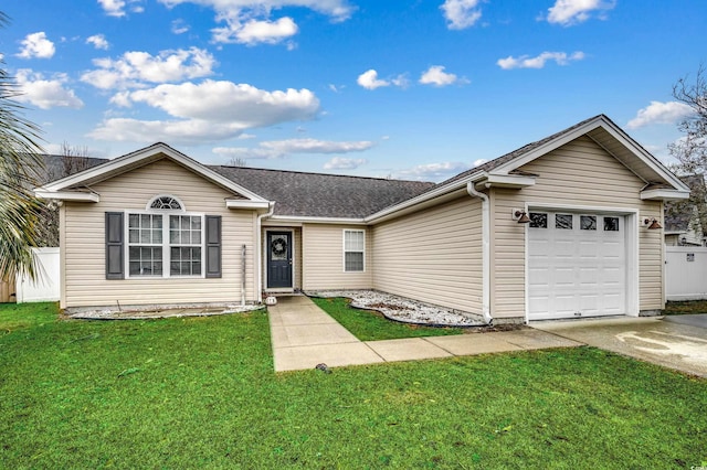 ranch-style house featuring a garage and a front lawn