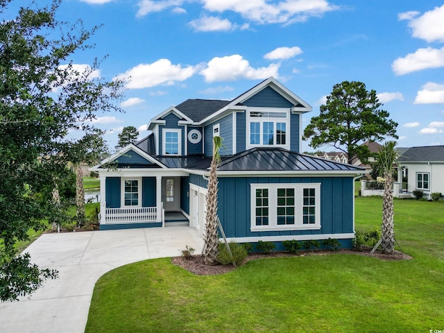 craftsman house featuring a front lawn, a porch, and a garage