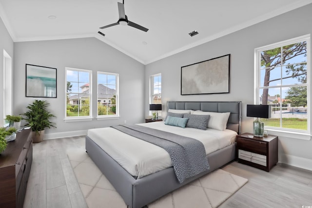 bedroom featuring ceiling fan, ornamental molding, light hardwood / wood-style flooring, and vaulted ceiling