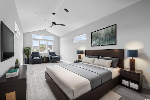 bedroom featuring hardwood / wood-style floors, ceiling fan, and lofted ceiling