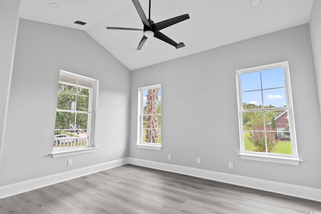 empty room featuring ceiling fan, lofted ceiling, and light wood-type flooring