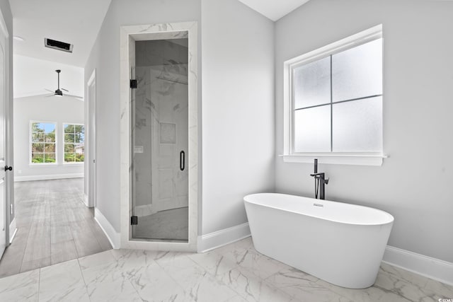 bathroom featuring ceiling fan, vaulted ceiling, and shower with separate bathtub