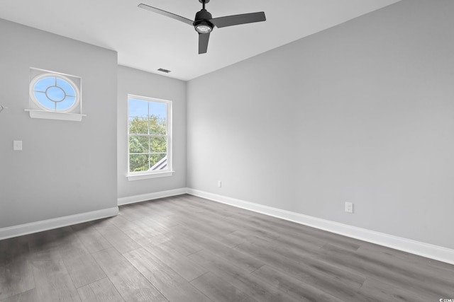 empty room featuring ceiling fan and dark hardwood / wood-style floors