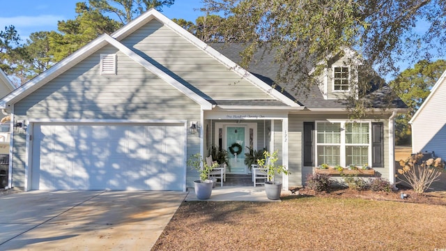 view of front of house featuring a garage and a porch