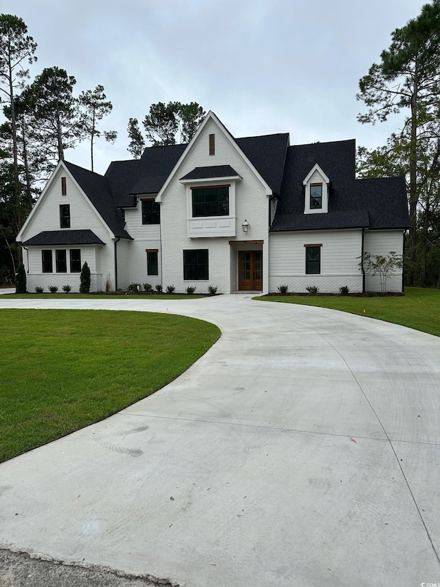 view of front of house with french doors and a front lawn