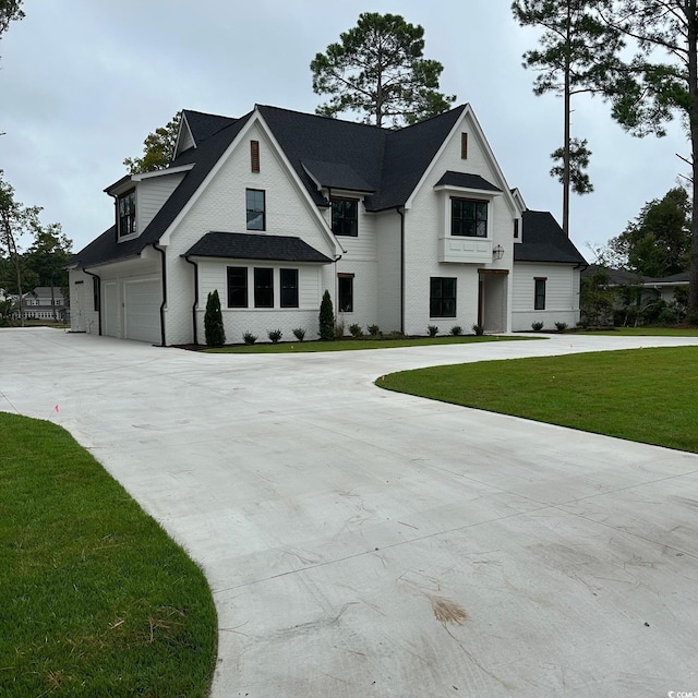 view of front of property with a garage and a front yard