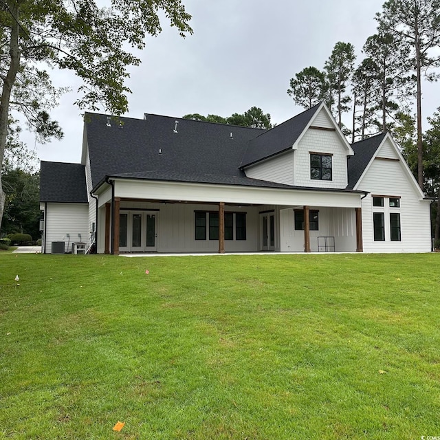 rear view of property featuring a yard