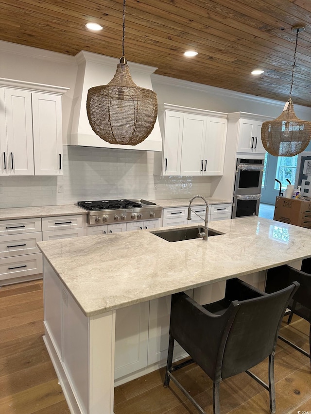 kitchen featuring white cabinetry, sink, dark hardwood / wood-style floors, and appliances with stainless steel finishes