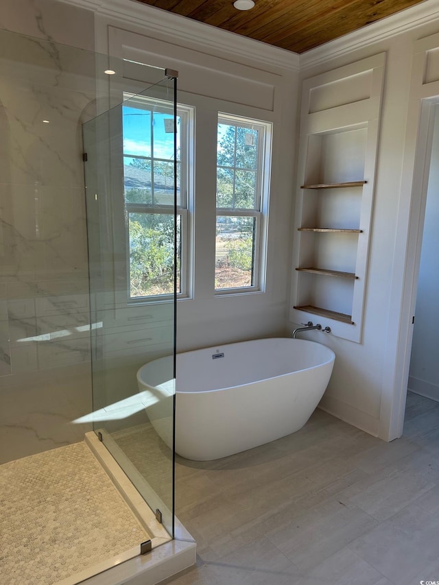 bathroom featuring built in shelves and independent shower and bath