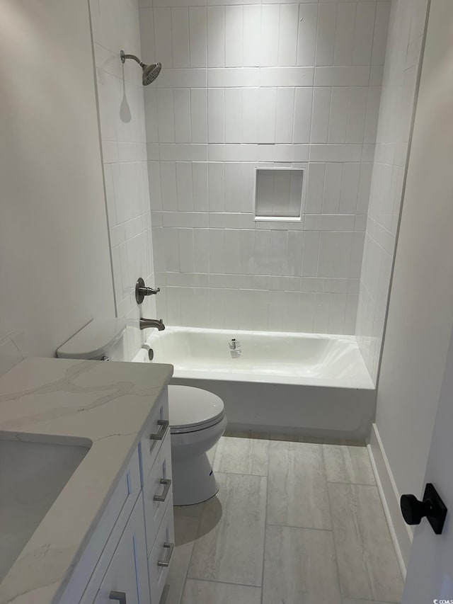 full bathroom with vanity, toilet, and tiled shower / bath