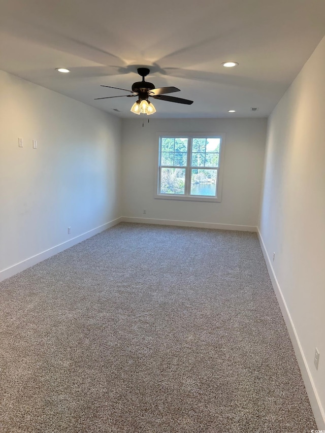 unfurnished room with ceiling fan and carpet floors