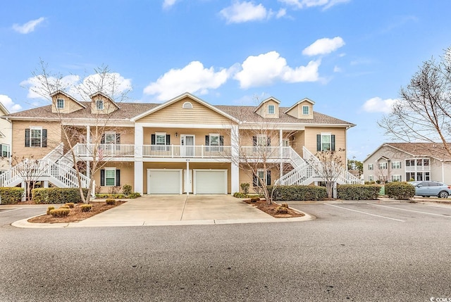 townhome / multi-family property featuring a porch and a garage