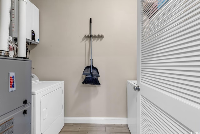 laundry area featuring light wood-type flooring and washer / dryer