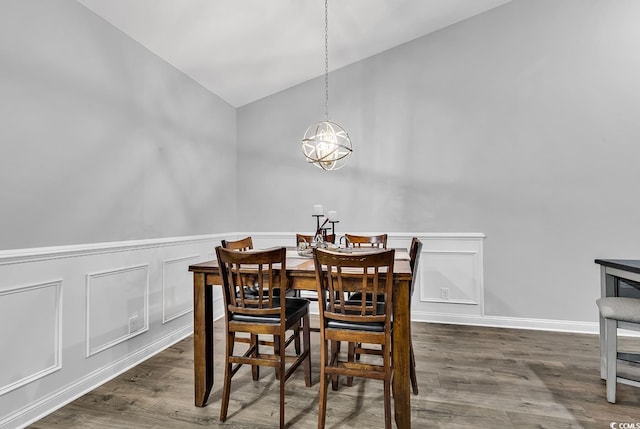 dining space featuring lofted ceiling and dark wood-type flooring