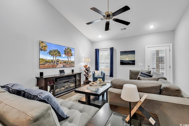 living room with ceiling fan, hardwood / wood-style floors, and lofted ceiling