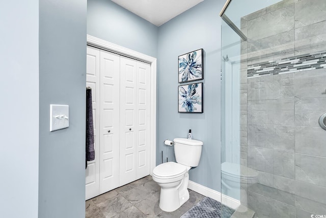 bathroom featuring toilet and a shower with door