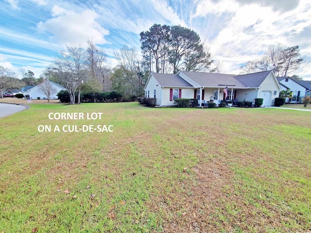 ranch-style house featuring covered porch, a front lawn, and a garage