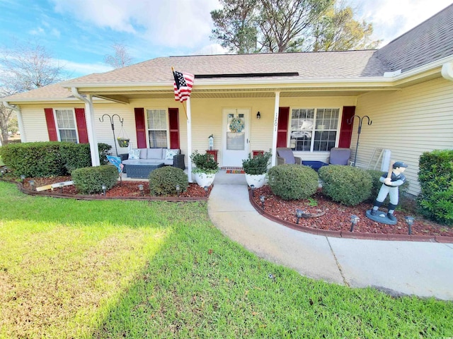 ranch-style home with a porch and a front yard