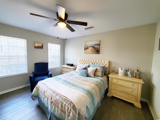 bedroom with ceiling fan and dark wood-type flooring