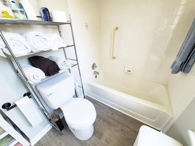 bathroom featuring toilet, tub / shower combination, and hardwood / wood-style flooring