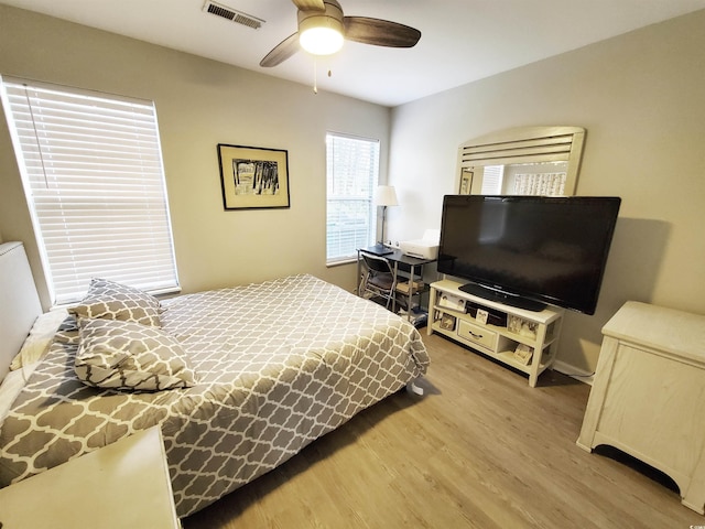 bedroom with ceiling fan and hardwood / wood-style flooring