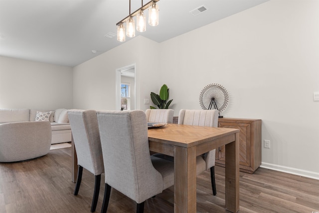 dining area featuring dark wood-type flooring