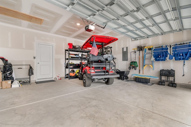 garage with a garage door opener and electric panel