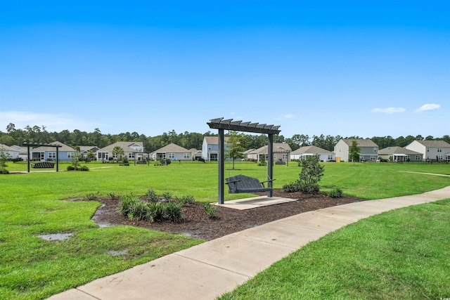 view of property's community with a lawn