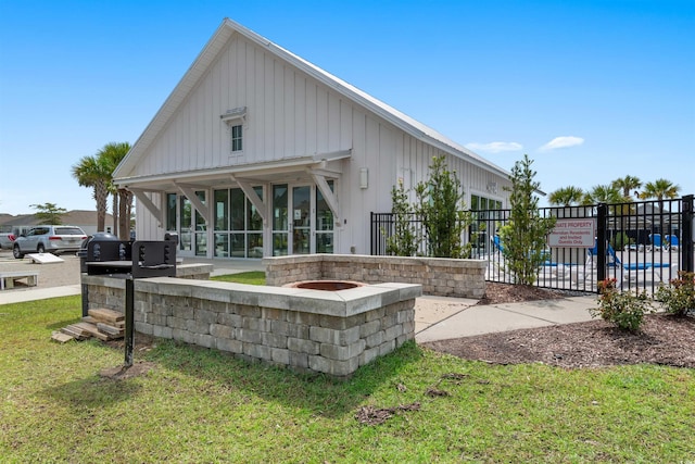 back of property featuring a sunroom and a yard