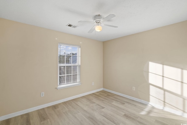 spare room with light hardwood / wood-style floors and ceiling fan