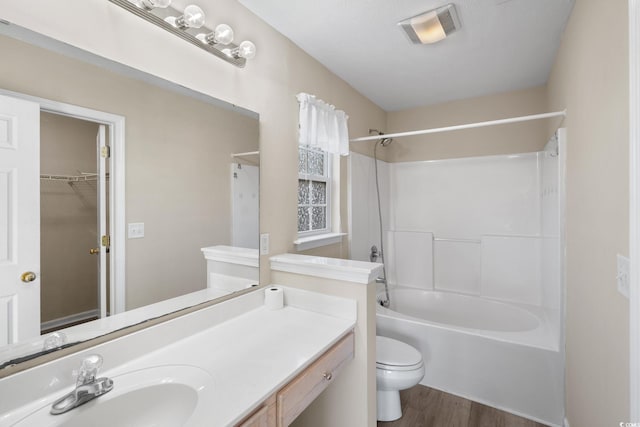 full bathroom with shower / tub combination, toilet, vanity, and wood-type flooring