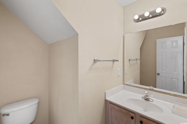 bathroom featuring toilet and vanity