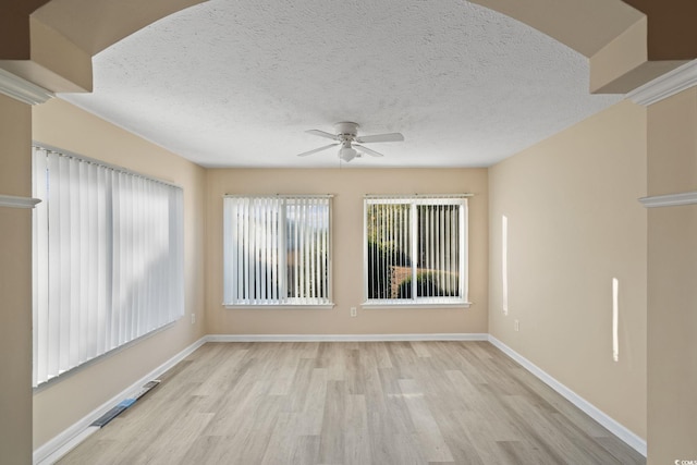 unfurnished room with light wood-type flooring, ceiling fan, and a textured ceiling