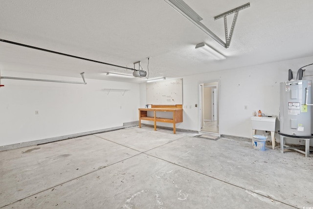 garage with sink, electric water heater, and a garage door opener