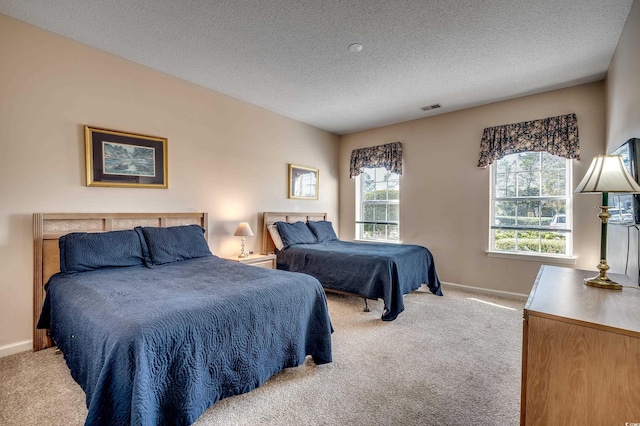 carpeted bedroom with a textured ceiling