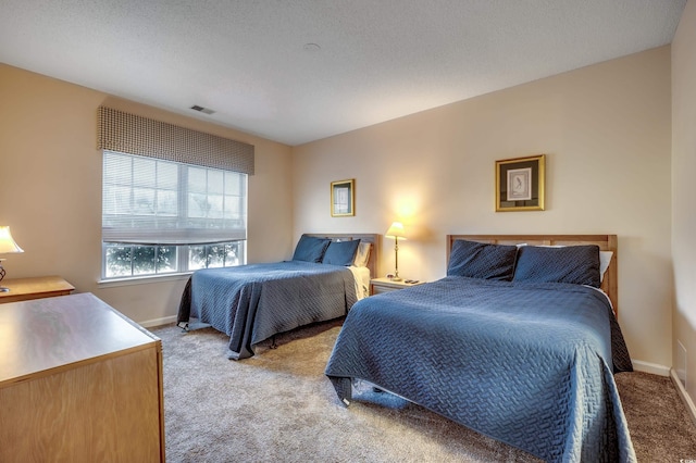 carpeted bedroom with a textured ceiling