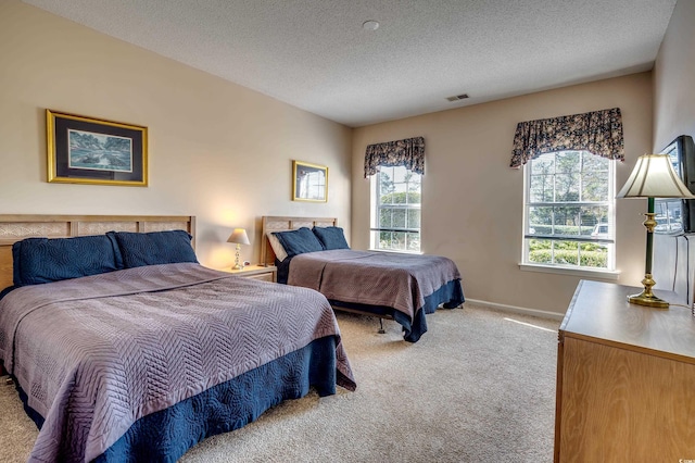 carpeted bedroom featuring a textured ceiling