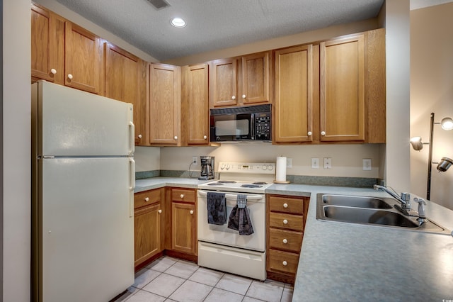 kitchen featuring a textured ceiling, white appliances, sink, and light tile patterned floors