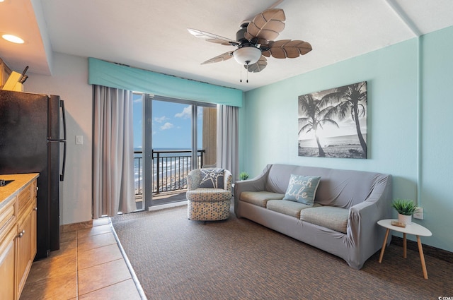 4800 S Ocean Blvd Unit 1007, North Myrtle Beach, SC 29582 - living area featuring light tile patterned floors, a ceiling fan, and a water view
