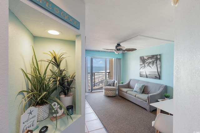 4800 S Ocean Blvd Unit 1007, North Myrtle Beach, SC 29582 - living area featuring tile patterned flooring, a water view, and ceiling fan