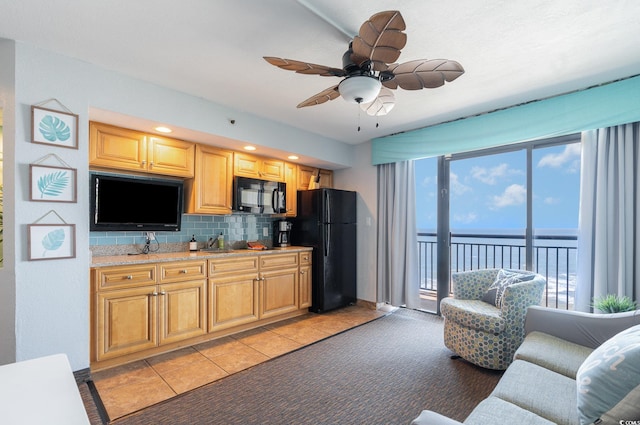 4800 S Ocean Blvd Unit 1007, North Myrtle Beach, SC 29582 - kitchen with black appliances, a water view, decorative backsplash, a ceiling fan, and light colored carpet